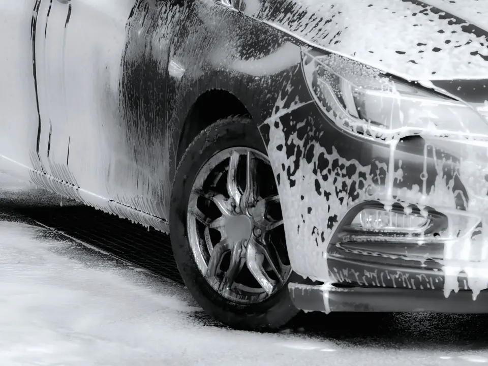 Close-up of a Car Being Washed with Soap Foam