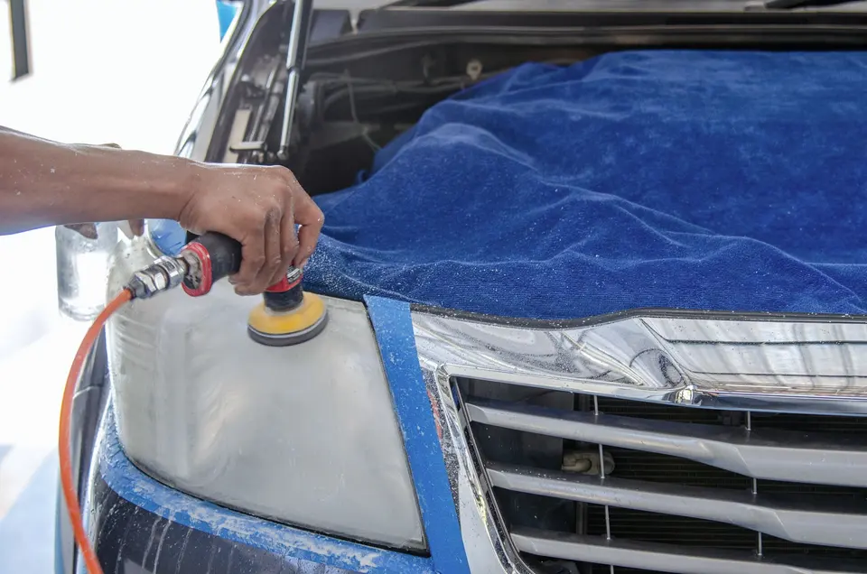  Person Using a Polishing Machine on the Car