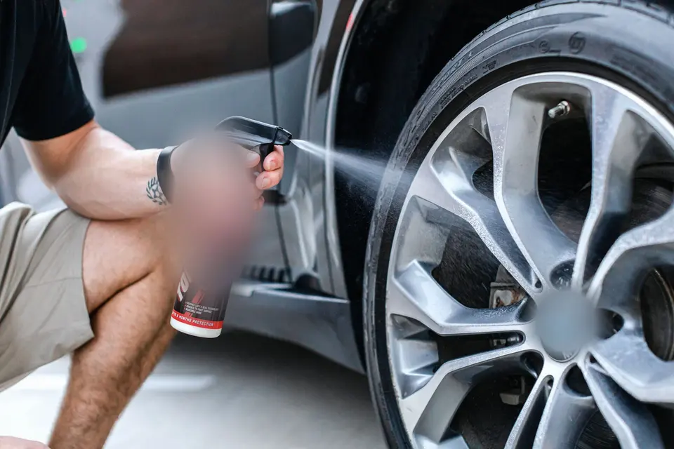 A Person Cleaning a Bmw Wheel