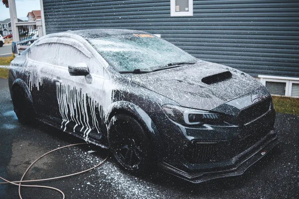 Luxury car under foam at car wash